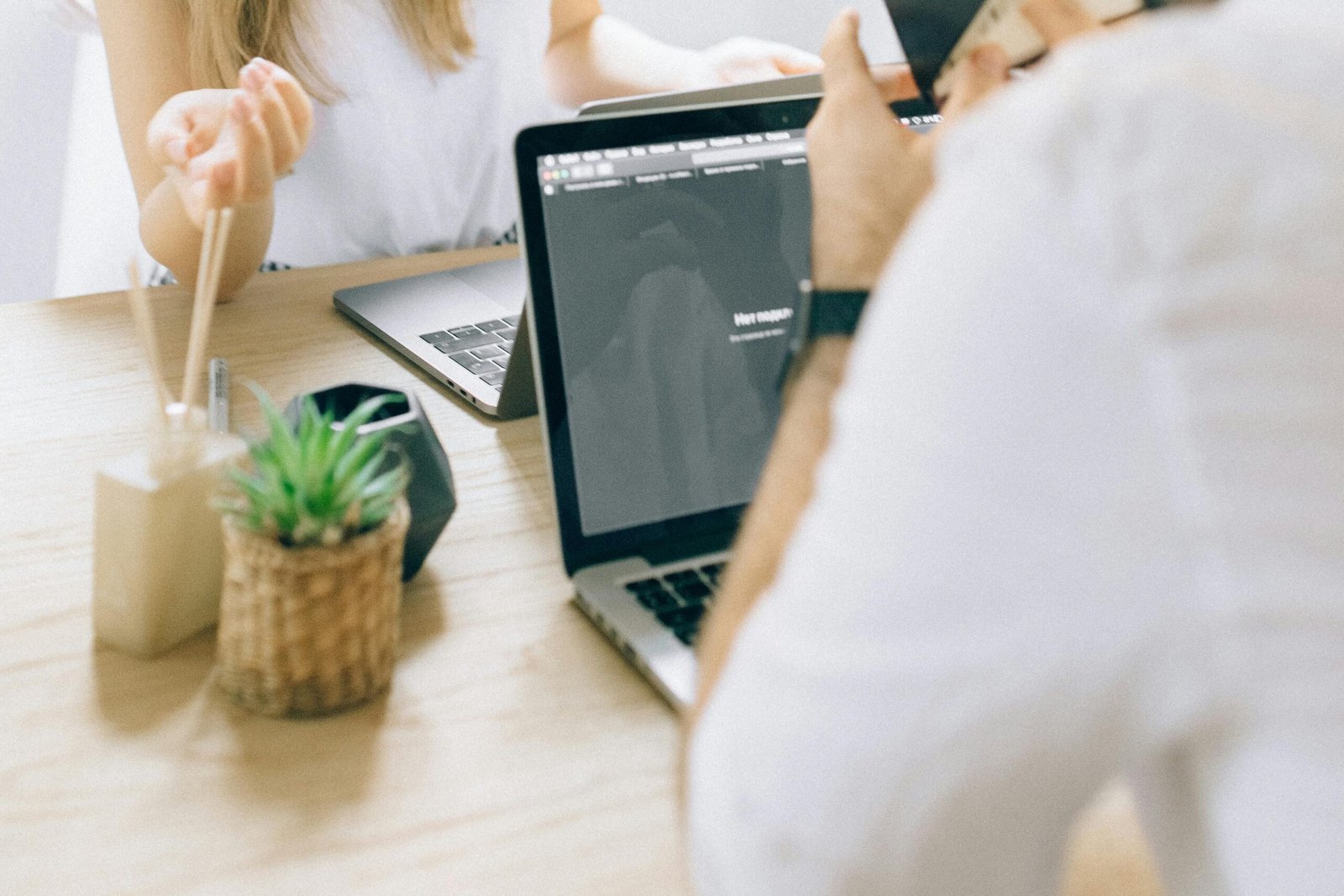A casual meeting between two colleagues in a bright office space.
